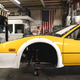 The nose of a highly modified yellow Ferrari 328 GTI